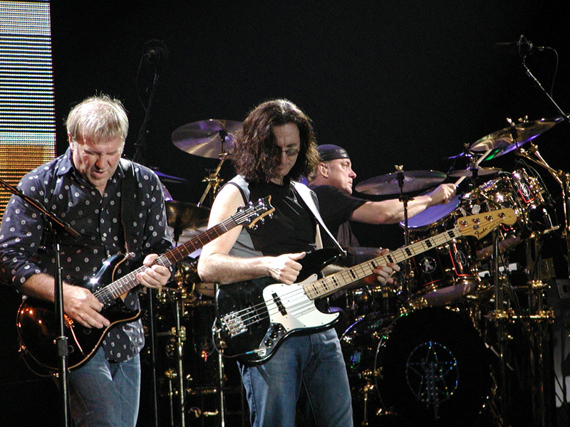 Alex Lifeson, Geddy Lee and Neil Peart performing in Milan, 2004.